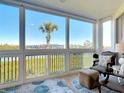 Waterfront lanai featuring lots of windows for natural light and comfortable seating at 434 Bouchelle Dr # 202, New Smyrna Beach, FL 32169