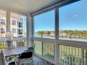 Beautiful waterfront lanai with table and chairs plus expansive water views at 434 Bouchelle Dr # 202, New Smyrna Beach, FL 32169