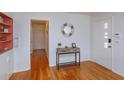 Inviting entryway with hardwood floors, stylish console table, decorative mirror, and a convenient coat closet at 476 Zelda Blvd, Daytona Beach, FL 32118