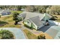 A lush green lawn and long driveway leads to this single Gathering home with a three car garage at 5170 Ne 64Th Ave, Silver Springs, FL 34488