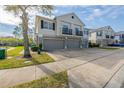 Shot of the home's exterior including the driveway, sidewalk, and small landscaped yard at 6612 S Goldenrod Rd # 104A, Orlando, FL 32822