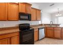 Cozy kitchen with wooden cabinets, neutral countertops, and modern appliances at 6612 S Goldenrod Rd # 104A, Orlando, FL 32822