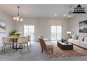 Staged living room with neutral tones, natural light, modern furnishings, and a cozy ambiance at 6612 S Goldenrod Rd # 104A, Orlando, FL 32822