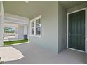 Inviting covered entryway with a modern front door and neutral exterior paint at 8013 Colby Cir, Orlando, FL 32817