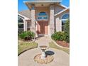 Inviting front entrance with a walkway leading to a double front door and a decorative bird bath at 907 Almond Tree Cir, Orlando, FL 32835