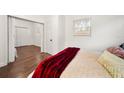 Bedroom featuring dark wood floors, white walls, and view to another room in the home at 908 Cannes Pl, Orlando, FL 32808