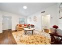 Bright living room with hardwood floors, a decorative rug, and comfortable seating arrangement at 908 Cannes Pl, Orlando, FL 32808