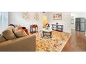 Inviting living room featuring a stylish sofa, decorative rug, and ample natural light at 908 Cannes Pl, Orlando, FL 32808