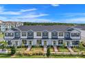 An aerial view of several two-story townhomes with well-maintained landscaping at 9314 Bolshoi Aly, Winter Garden, FL 34787