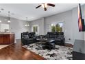 Spacious living room boasts hardwood floors, a ceiling fan, recessed lighting, and neutral paint at 10876 Eclipse Lily Way # 60, Orlando, FL 32832