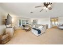 Spacious living room with ceiling fan, cozy seating, and a bay window providing natural light at 13224 Casper Ln, Clermont, FL 34711