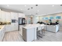 Modern kitchen with white cabinets, quartz countertops, and stainless steel appliances at 13800 Chauvin Ave, Orlando, FL 32827