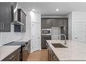 Stylish kitchen boasts dark cabinets, stainless steel appliances, and white backsplash at 13809 Luna Harvest Ave, Winter Garden, FL 34787