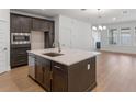 Well-appointed kitchen with island, stainless steel appliances, and dark cabinetry at 13809 Luna Harvest Ave, Winter Garden, FL 34787