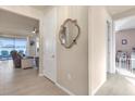 Hallway featuring a decorative mirror, tile floors, and views into the living room and bedroom at 1452 Hopedale Pl, Sanford, FL 32771
