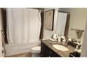 Bathroom with a white shower curtain, dark vanity, granite counters, and modern fixtures at 150 E Robinson St # 12A-15 / 1216, Orlando, FL 32801