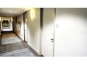 Hallway view of the condo showing unit door 1216 with carpet squares and fire hose at 150 E Robinson St # 12A-15 / 1216, Orlando, FL 32801