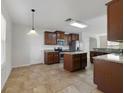 Bright kitchen with stainless steel appliances, wood cabinets, and center island at 16217 Saint Augustine St, Clermont, FL 34714