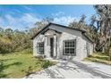 Inviting single-story home boasts lush lawn and concrete driveway under a sunny blue sky at 179 Douglas Ave, Chuluota, FL 32766