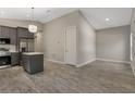 Modern kitchen with gray cabinets, stainless steel appliances, and a stylish kitchen island at 179 Douglas Ave, Chuluota, FL 32766