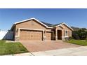 Attractive single-story home featuring a three-car garage, solar panels and a well-maintained front yard at 1855 Partin Terrace Rd, Kissimmee, FL 34744
