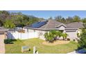 This home showcases solar panels, a fenced yard, and well-maintained landscaping at 188 Whispering Pines Way, Davenport, FL 33837