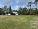 Expansive backyard featuring a screened porch and plenty of space for outdoor activities at 1955 Mustang Ct, St Cloud, FL 34771