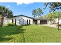 Charming single-story home with a well-manicured lawn and attached two-car garage at 2555 Sweetwater Trl, Maitland, FL 32751