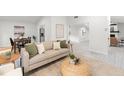 Bright living room with modern decor, including a plush sofa, stylish rug, and wood-look flooring at 2555 Sweetwater Trl, Maitland, FL 32751