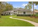 Well maintained single story home with manicured lawn and decorative bushes along the walkway at 2991 Timpana Pt, Longwood, FL 32779