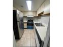 Functional kitchen with stainless steel refrigerator, electric stove, and white countertops at 4215 S Semoran Blvd # 2, Orlando, FL 32822