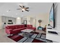 Open-concept living room with view to the kitchen, seamlessly blending living and dining spaces at 429 N Andrea Cir, Haines City, FL 33844