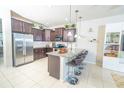 Modern kitchen with stainless steel appliances, granite countertops, and bar stool seating at 5156 Caspian St, St Cloud, FL 34771