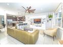 Open concept living room with kitchen view, sleek furniture, and a large entertainment center at 5156 Caspian St, St Cloud, FL 34771