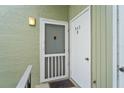 Close up of unit front door with welcome mat, light and door bell at 543 Fairways Dr # B, Ocala, FL 34472