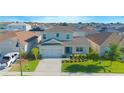 Two-story home featuring a well-manicured lawn and an attached two-car garage in a residential neighborhood at 5709 Sagunto Dr, Davenport, FL 33897