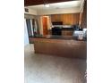 Kitchen featuring wood cabinets, black countertops, and a large island at 6 Barnard Ct, Maitland, FL 32751