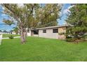 A charming single-story home with a spacious front yard and mature trees at 606 Forest Dr, Casselberry, FL 32707