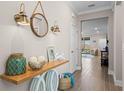 Bright entryway featuring a console table with decorative items and wood-look tile flooring at 637 Conservation Blvd, Groveland, FL 34736