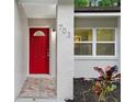 Close-up of the front door showing the house number and a decorative window feature at 703 Sailfish Rd, Winter Springs, FL 32708