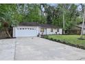 Front exterior showcasing the home's facade, driveway, and well-maintained lawn at 703 Sailfish Rd, Winter Springs, FL 32708
