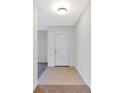 Bright entryway featuring tile flooring transitioning to carpet and a white front door at 734 Andalusia Loop, Davenport, FL 33837