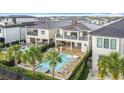 Aerial view of a backyard oasis featuring a sparkling pool, spa, and ample seating for relaxation and entertainment at 1003 Jack Nicklaus Ct, Kissimmee, FL 34747