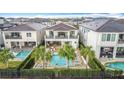 Stunning aerial view of a home with a luxurious pool, spa, and manicured backyard, perfect for outdoor living at 1003 Jack Nicklaus Ct, Kissimmee, FL 34747
