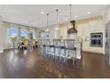 A gourmet kitchen featuring a spacious island with seating, hardwood floors, and modern stainless steel appliances at 16629 Broadwater Ave, Winter Garden, FL 34787