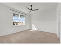 Bright bedroom featuring neutral carpet, a modern ceiling fan and a large window at 1773 Groveline Rd, St Cloud, FL 34771