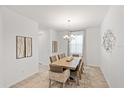 Elegant dining room with a chandelier, neutral decor, and natural light at 2099 Derwent Dr, Davenport, FL 33896