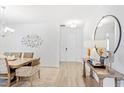 Bright hallway featuring wood floors, stylish mirror, and elegant decor at 2099 Derwent Dr, Davenport, FL 33896