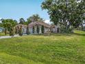 Sprawling lawn and mature trees frame this charming single-story home at 2200 Pine Needle Trl, Kissimmee, FL 34746