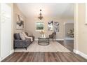 Comfortable living room featuring a decorative chandelier, neutral paint, and stylish furniture at 2335 Coldstream Dr, Winter Park, FL 32792